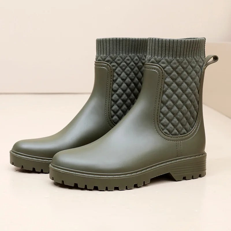 Women's black leather ankle boots with cozy knit side panel, sleek silhouette for casual elegance