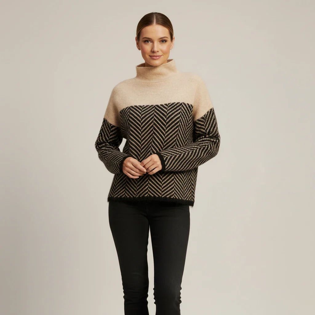 Women's oversized color block turtleneck sweater with bold chevron pattern detail in cool-weather style