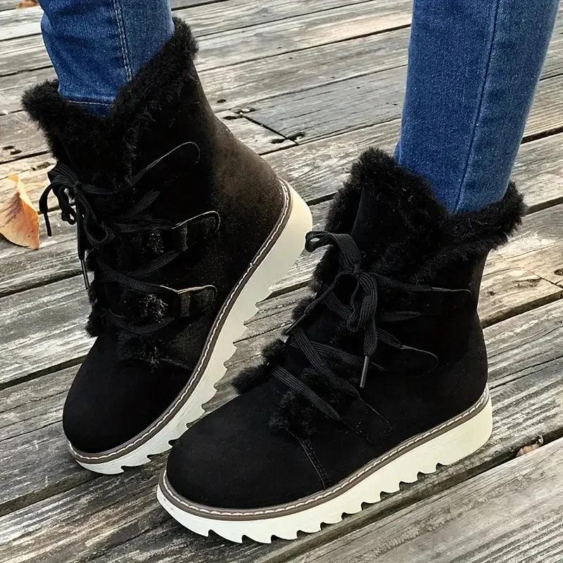 Black plush-lined winter boots with sleek silhouette and cozy faux-fur interior lining