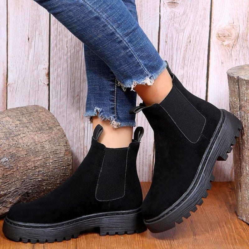 Black faux suede chunky ankle boots with plush fluffy lining and bold block heel silhouette