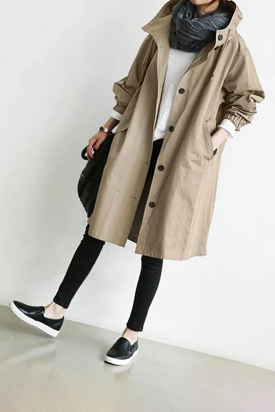 Beige hooded trench coat with sleek modern cut and integrated weather-resistant hood