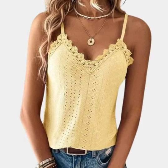 Women's white V-neck top with eyelet embroidery and delicate lace patch details