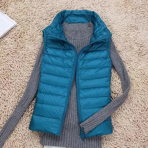 Women's slim lightweight sleeveless puffer vest for cold weather layering, insulated zip-front design