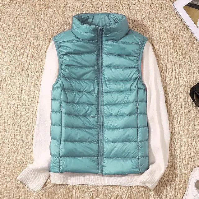 Women's slim lightweight sleeveless puffer vest for cold weather layering, insulated zip-front design