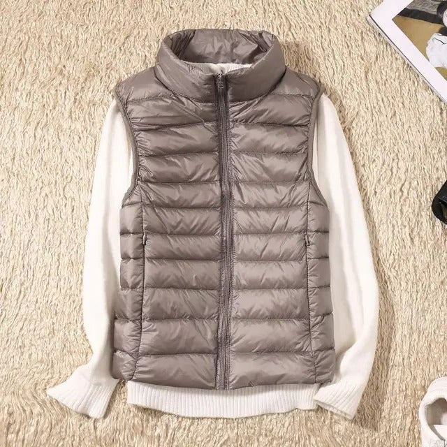 Women's slim lightweight sleeveless puffer vest for cold weather layering, insulated zip-front design