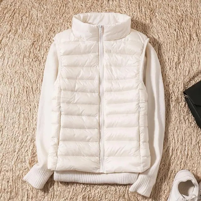 Women's slim lightweight sleeveless puffer vest for cold weather layering, insulated full-zip closure