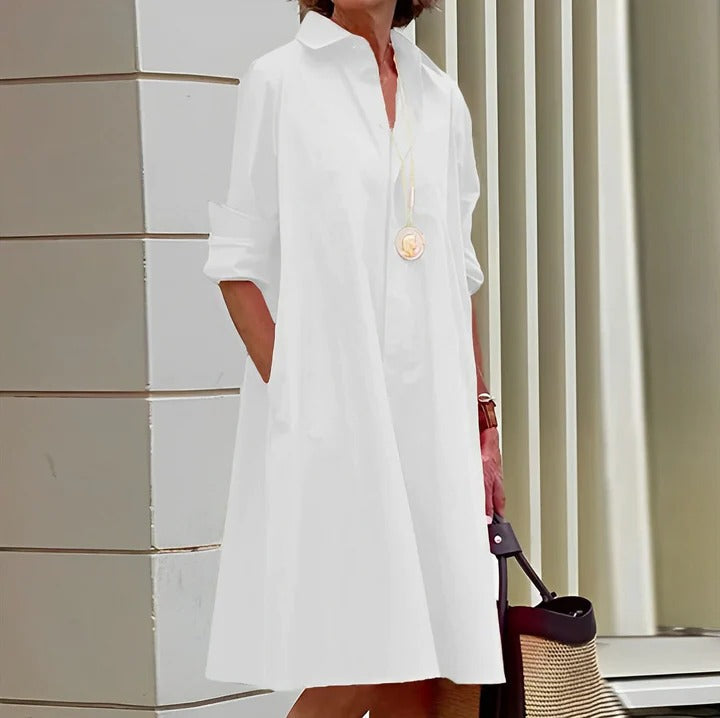 Relaxed white shirt-style dress with tailored collar, full-length hem, and casual everyday silhouette