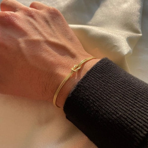 Women's minimalist love knot bracelet in sleek silver with timeless knot detail for everyday elegance