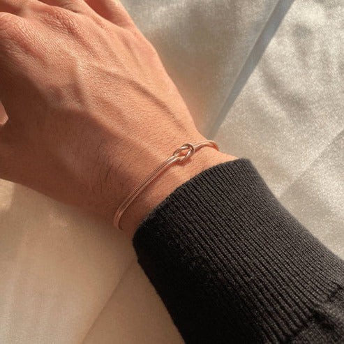 Women's minimalist love knot bracelet in elegant silver, timeless knot detail for everyday wear