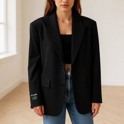 Women's oversized blazer in neutral tone with classic lapels and lightweight structured fabric for a polished fit