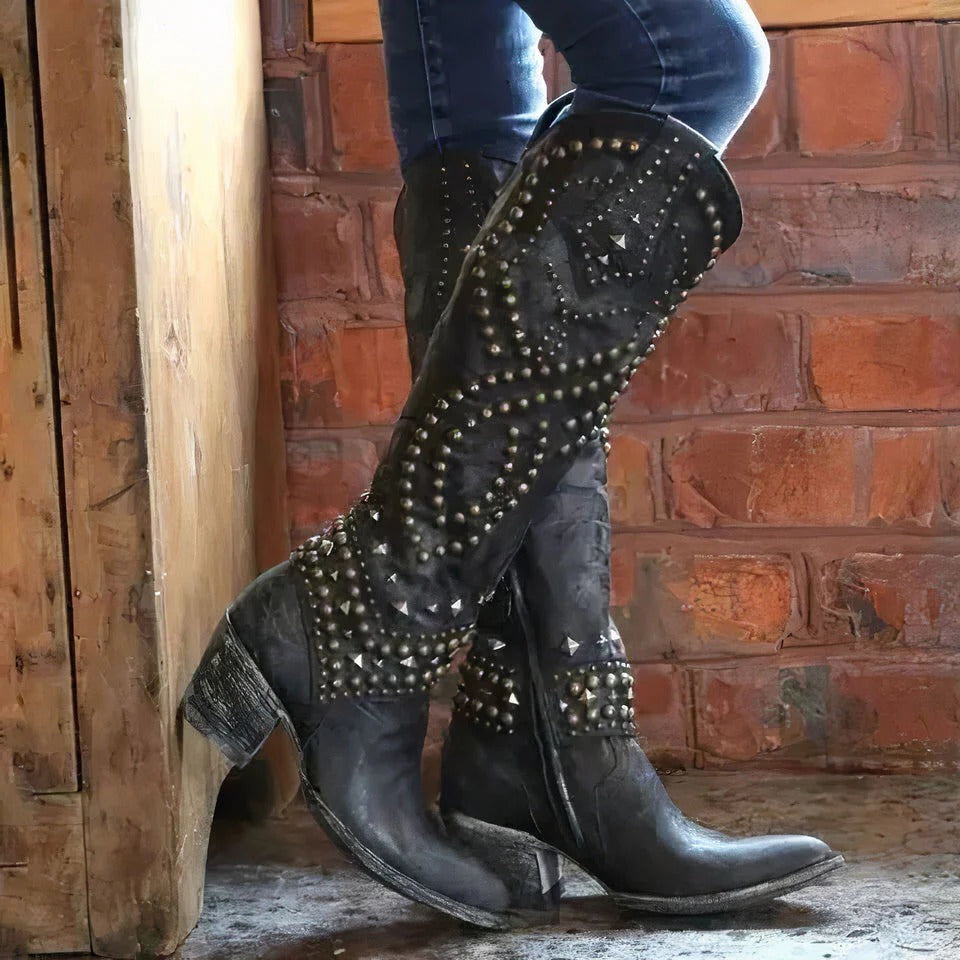 Women's brown leather knee-high western boots with pointed toe and studded accents for a bold look