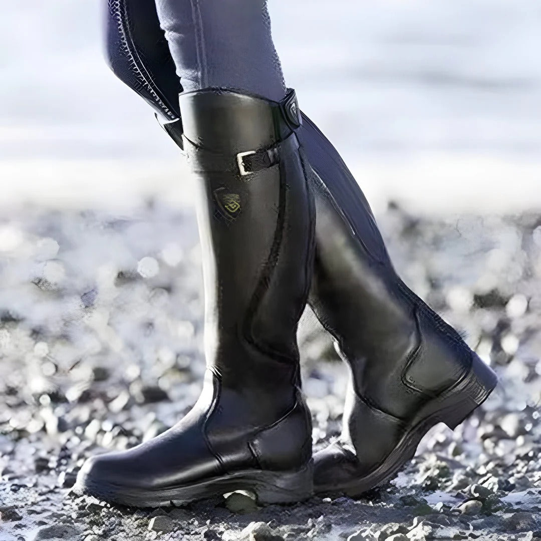 Women's black waterproof knee-high boots with rugged grip outsole for all-weather traction
