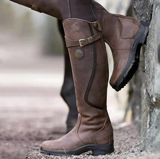 Women's black waterproof knee-high boots with rugged grip sole for all-weather outdoor wear