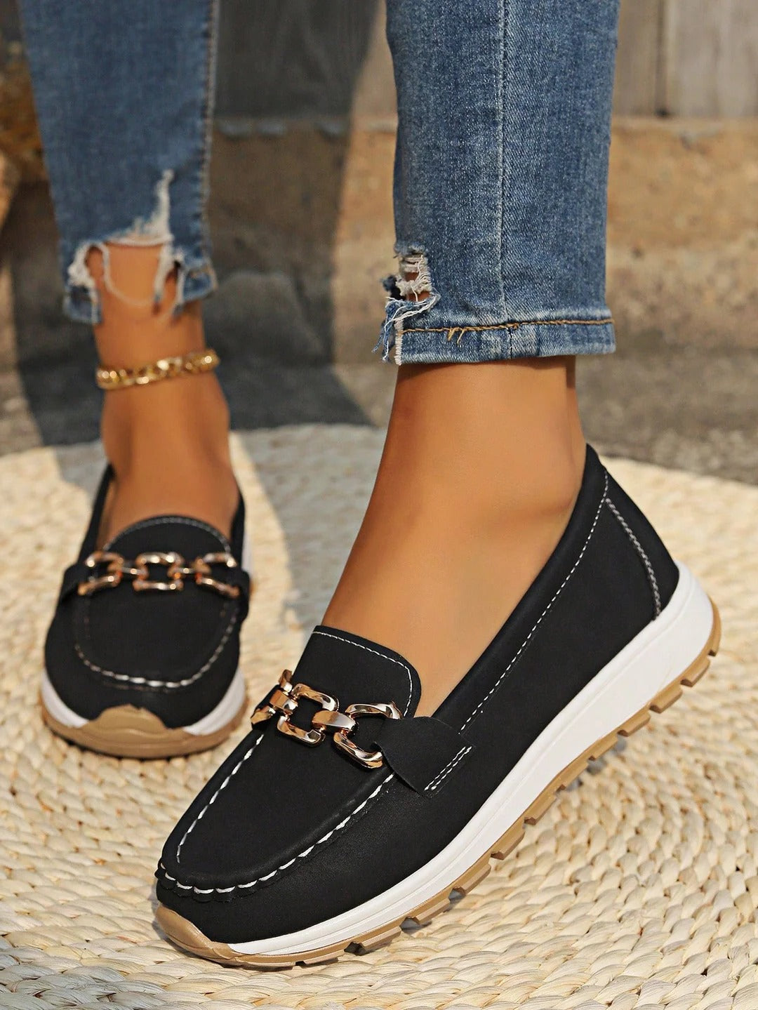 Women's slip-on loafers in neutral tones with sleek buckle detail and flat wedge sole for all-day comfort