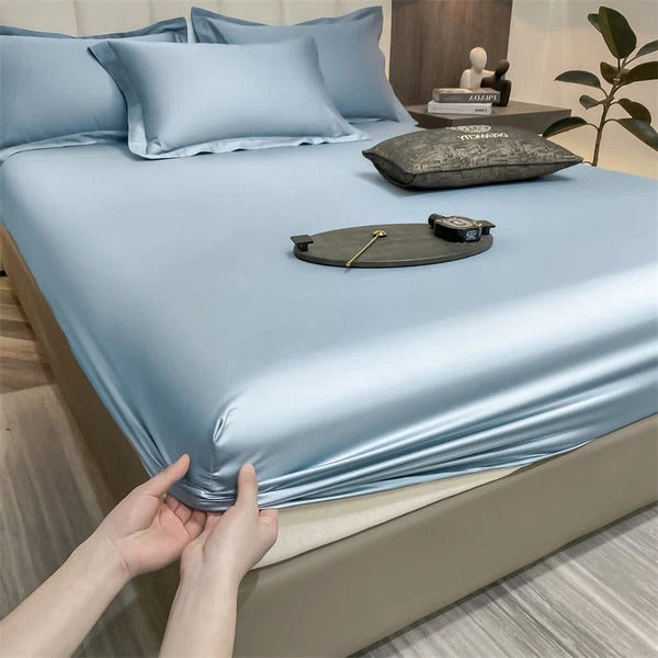Fitted bed sheets in neutral tones, snug elastic edges, breathable fabric for deep mattresses