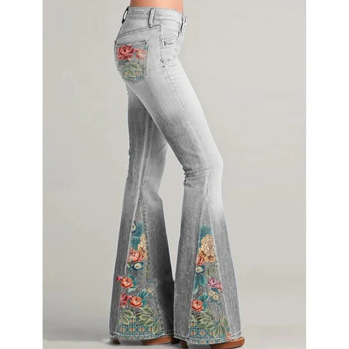 Women's vintage blue flare jeans with delicate floral embroidery along pockets and legs