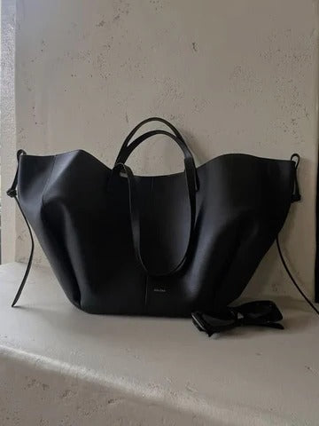 Vintage women's tote bag in classic neutral tones, spacious structured silhouette with elegant retro-inspired design