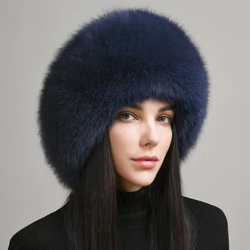 Women's winter hat with integrated earmuffs, dense fur texture, full coverage, refined cold-weather style
