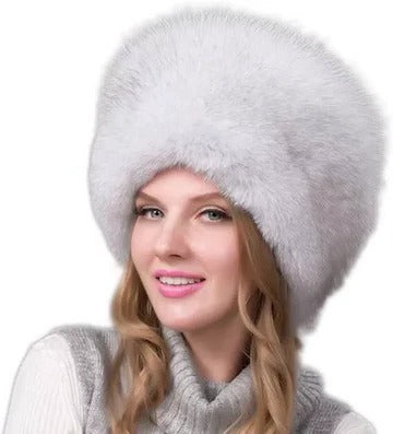 Women's winter hat with integrated earmuffs, dense fur texture, full coverage, refined cold-weather style