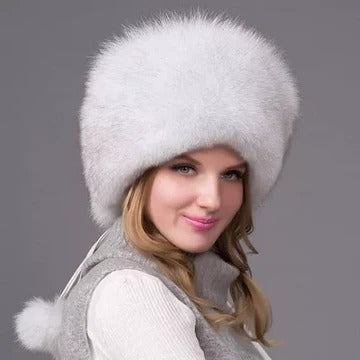 Women's winter hat with integrated earmuffs, dense fur texture, full ear coverage, cold-weather style