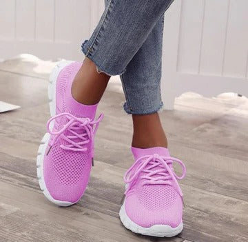 Women's white everyday sneakers with cushioned interior, structured sole, and versatile low-top silhouette