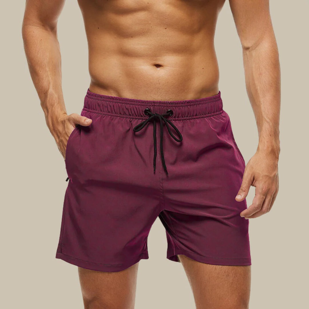 Men's navy blue relaxed-fit swim shorts with quick-dry fabric, ideal for beach and water activities