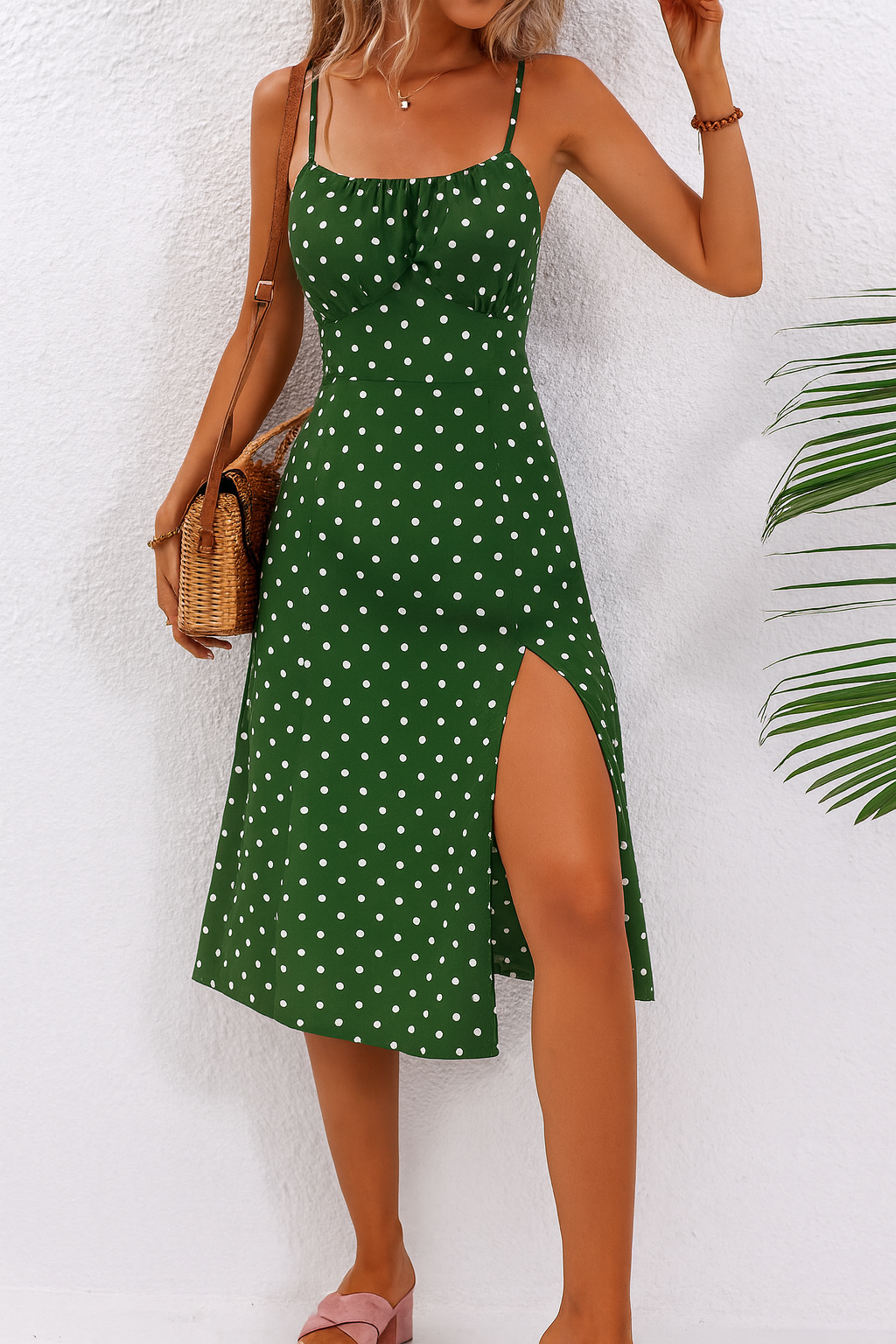 Black and white polka dot midi dress with delicate straps, soft neckline, and breezy side slit