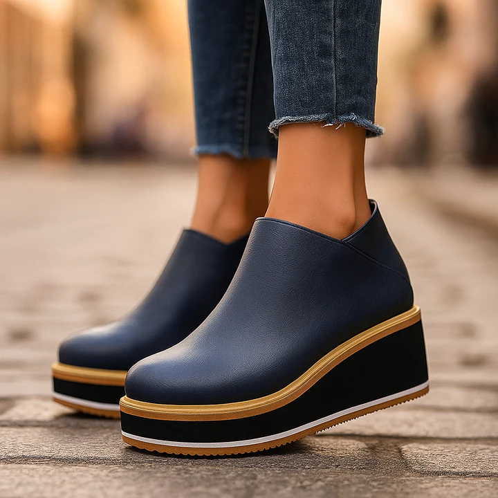 Women's beige soft leather platform boots with elevated sole and sleek minimalist silhouette