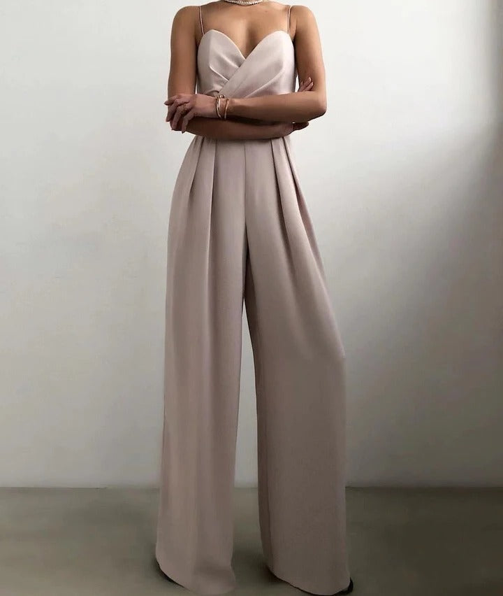 Women's sleeveless jumpsuit with shaped waist, clean neckline, structured silhouette in versatile chic style