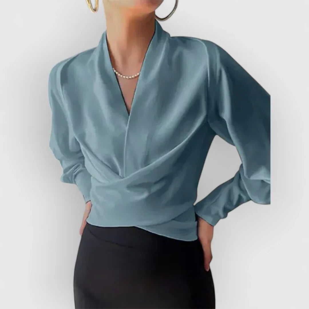 Women's ivory wrap blouse with dramatic puff sleeves and tailored cut for polished office style