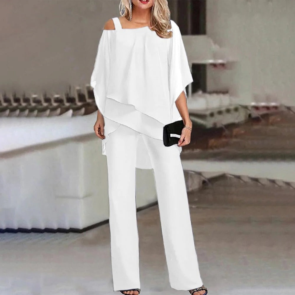 Women's cold shoulder wide leg jumpsuit with flowing chiffon overlay in elegant dressy style