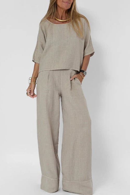 Neutral two-piece set with cropped relaxed top and wide high-waisted trousers for versatile wear
