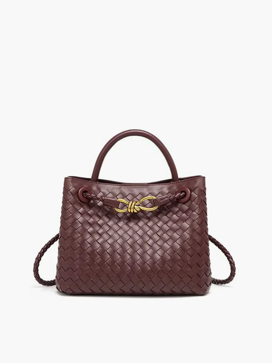 Black structured woven tote bag with dual carry straps and gold knot accent detail