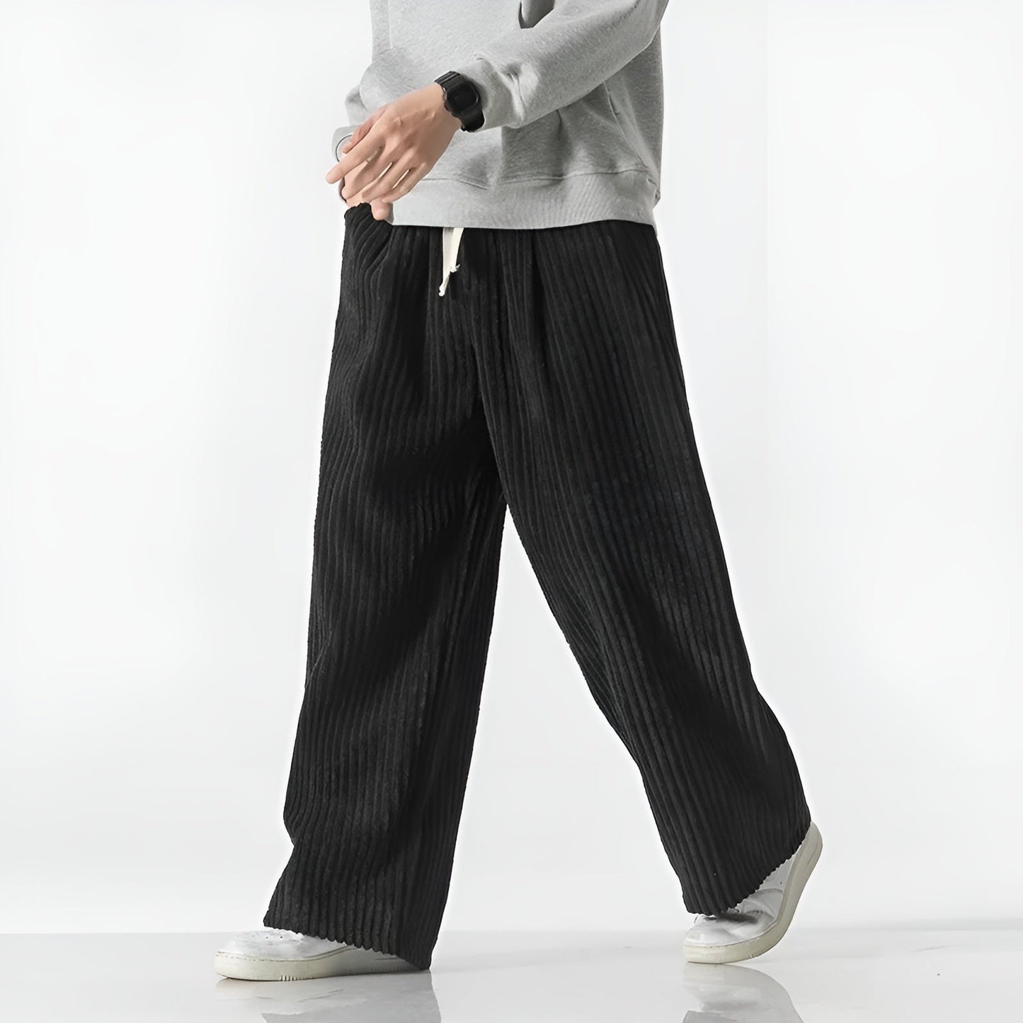 Relaxed corduroy pants with densely ribbed texture, elastic drawstring waist, and casual wide-leg fit