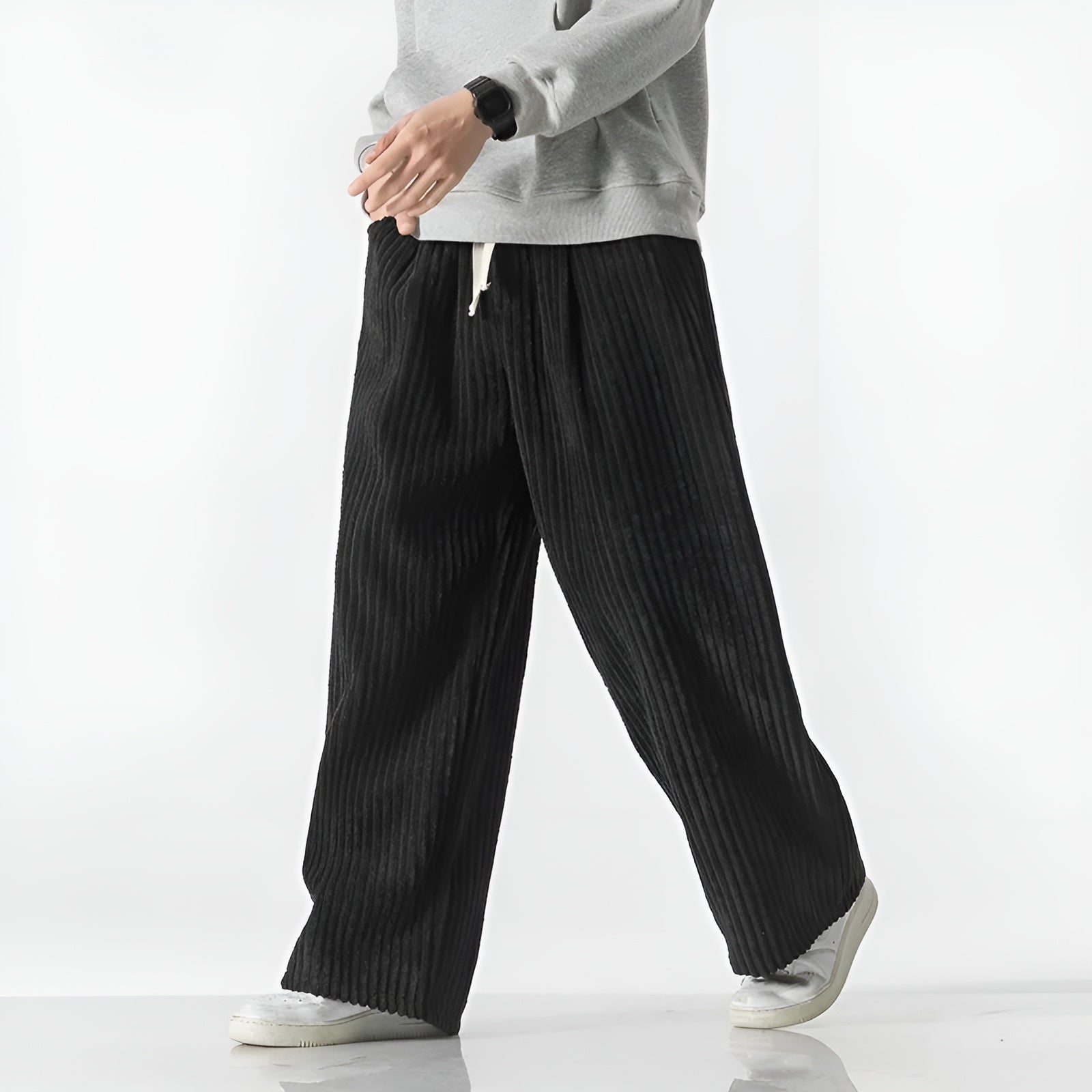 Relaxed corduroy pants with densely ribbed texture, elastic drawstring waist, and casual wide-leg fit