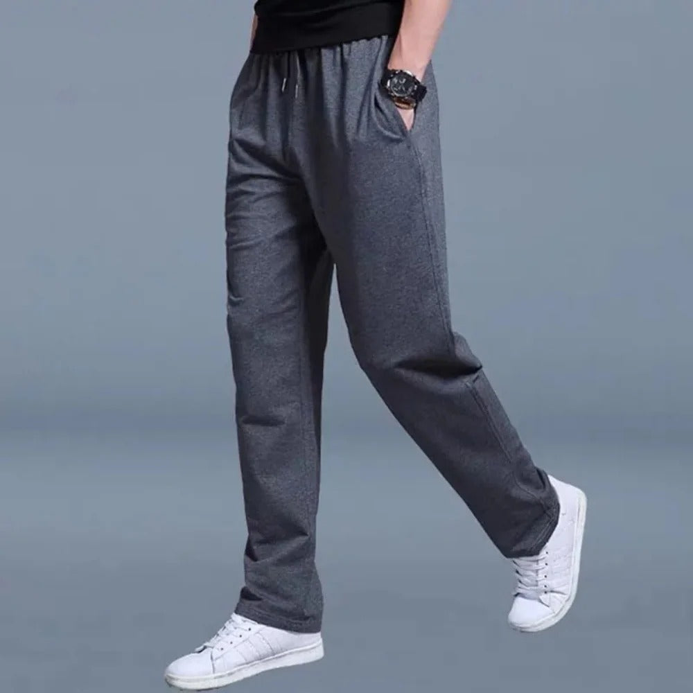 Men's gray cotton-polyester sweatpants with elastic waist and deep side pockets for everyday wear