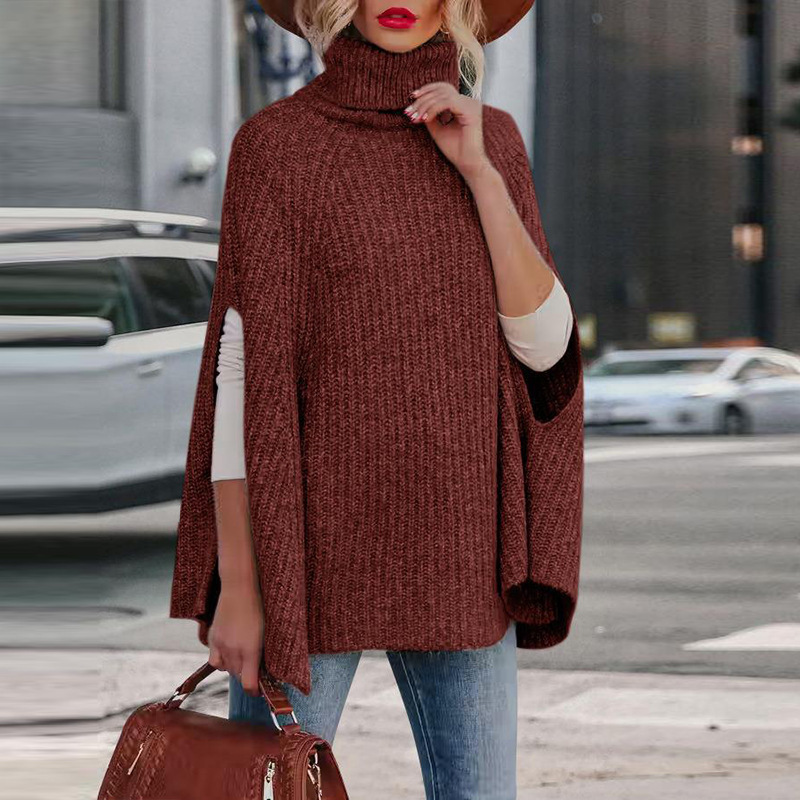 Women's wool blend cape in neutral tone, high neck, relaxed drape with functional arm slits for autumn