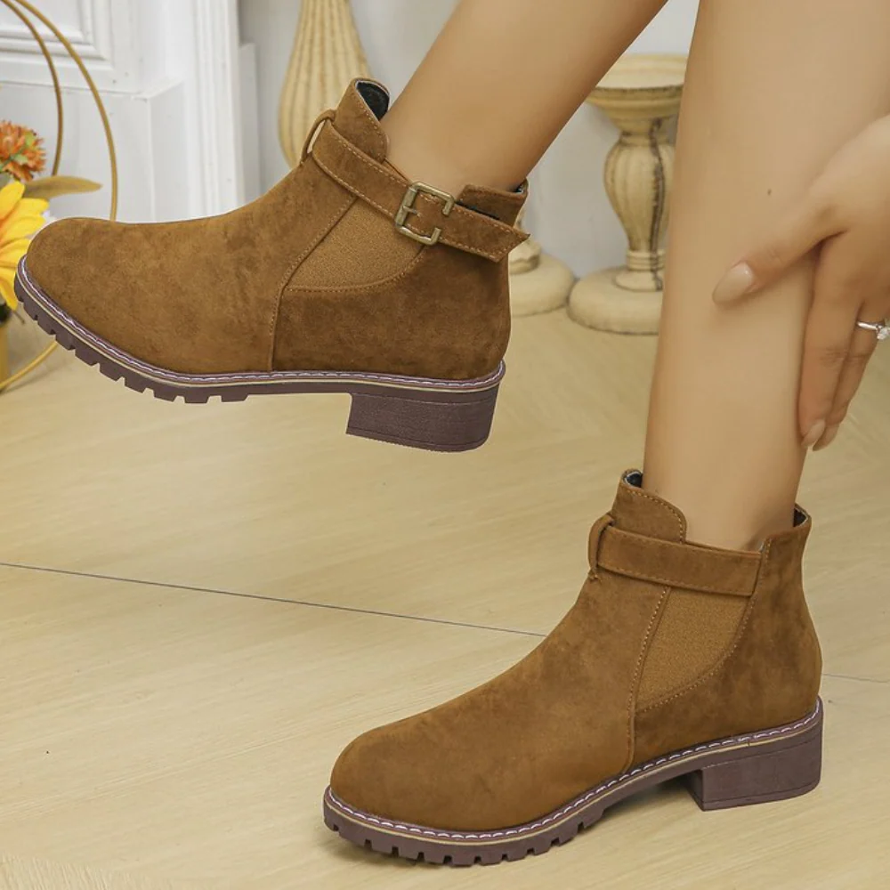 Women's suede-texture ankle boots with buckle strap, elastic panel, and gripped sole for versatile wear