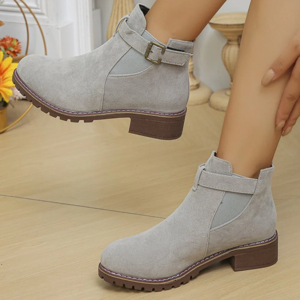Women's suede-texture ankle boots with buckle strap, elastic panel, and gripped sole for versatile wear