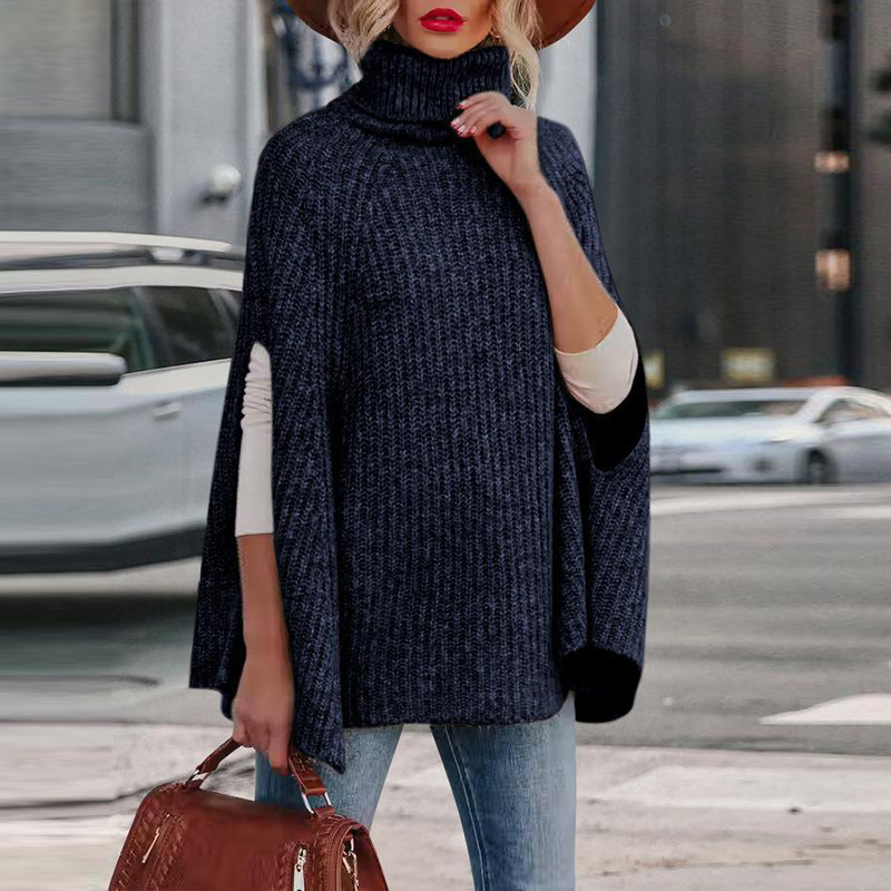 Women's wool blend cape in neutral tone, high neck, relaxed drape with arm slits for autumn layering