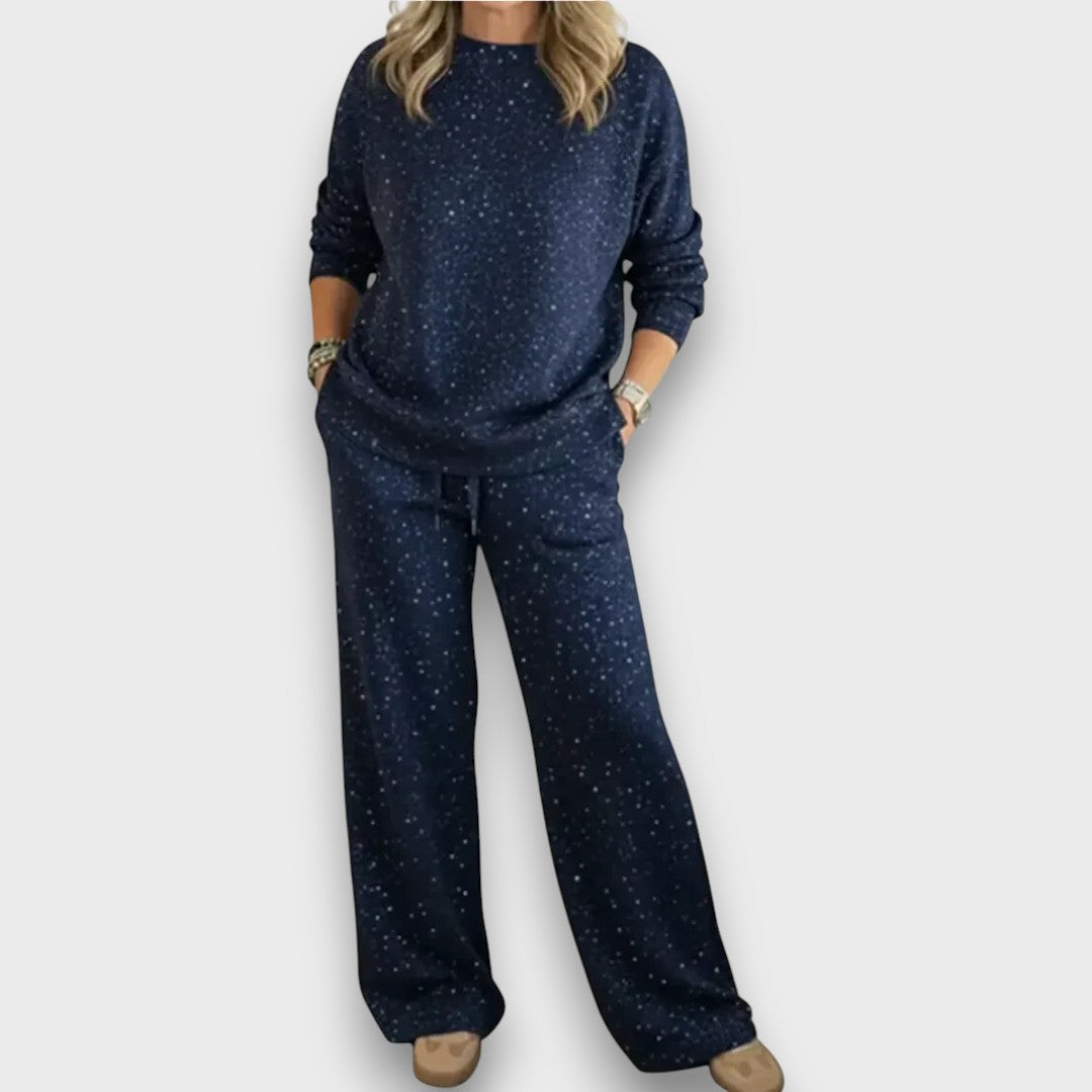 Relaxed two-piece lounge set in neutral tones with flowing top and wide-leg bottoms for effortless style