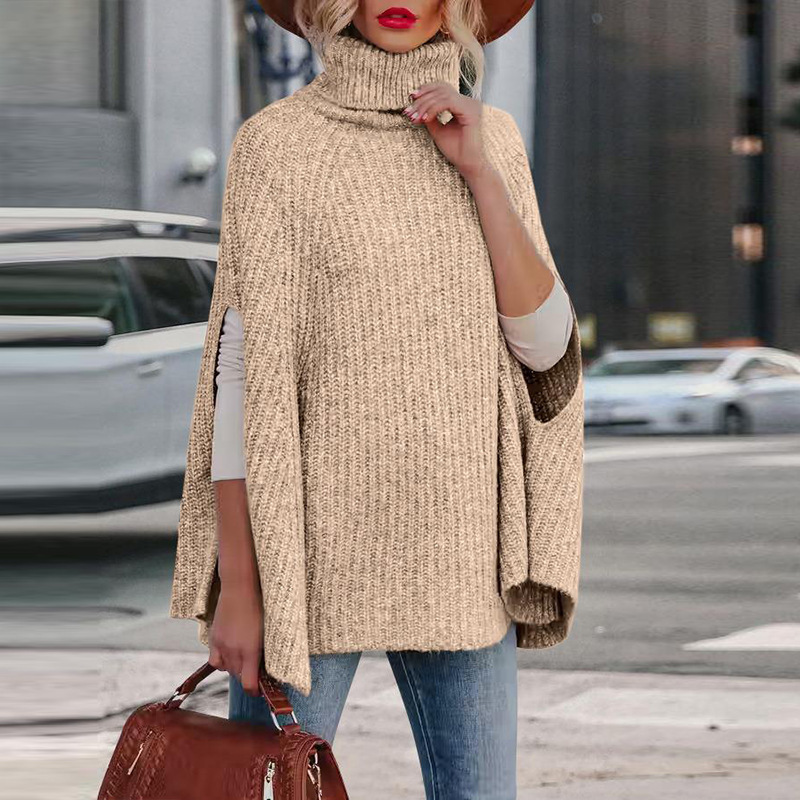 Women's wool blend cape in neutral tone, high neck, relaxed drape with functional arm slits for autumn