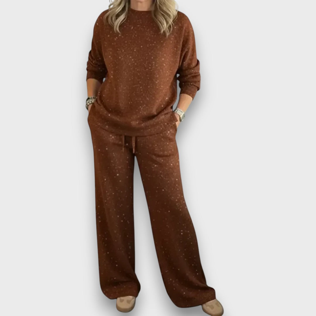 Relaxed two-piece lounge set in soft neutral tones with flowing top and wide-leg bottoms for effortless style