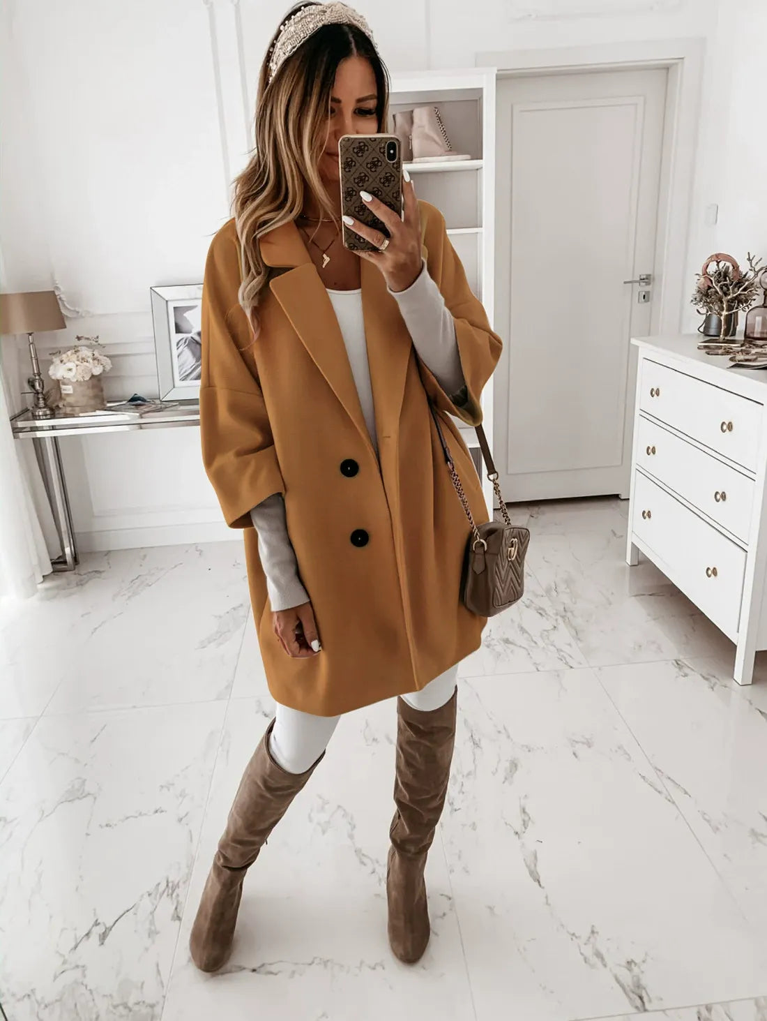 Women's oversized wool coat with lapel collar, three-quarter sleeves, and button-front closure