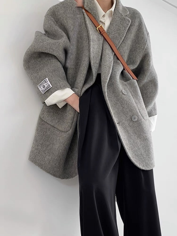 Women's oversized double-breasted wool coat, turndown collar, mid-thigh length, relaxed elegant fit