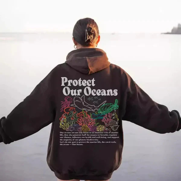 Women's oversized gray hoodie sweatshirt with bold marine graphic back print, casual coastal street style