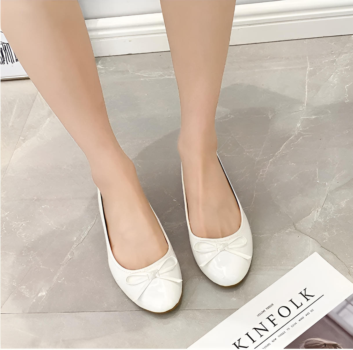 Black leather ballet flats with built-in comfort support, polished round-toe silhouette for all-day wear