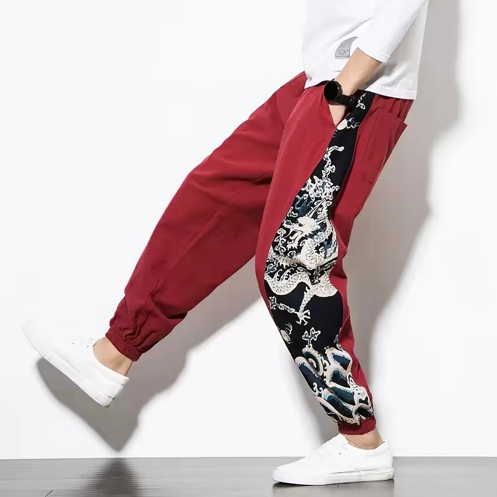 Black cotton-linen harem pants with Japanese dragon artwork along the sides, tapered hem, relaxed modern fit