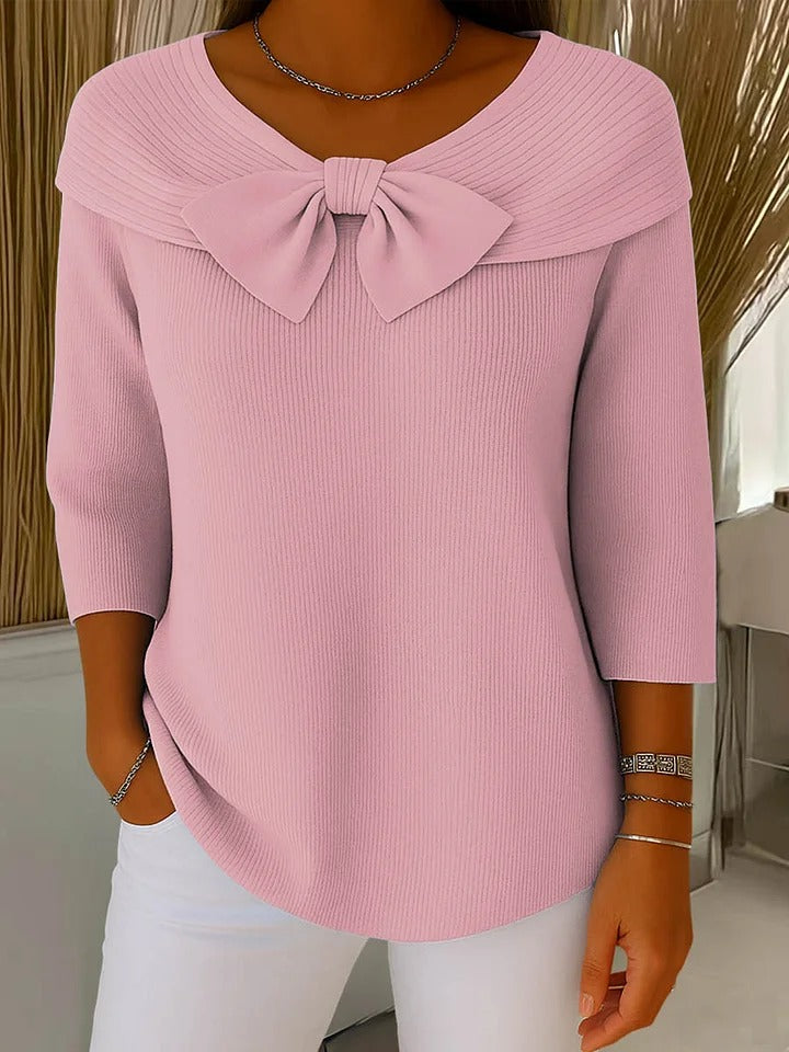 Women's round neck sweater with delicate bow accent, soft feminine style for effortless layering
