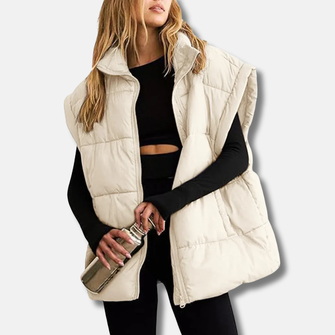 Women's quilted puffer vest in neutral tone, hip-length silhouette with stand collar for casual layering